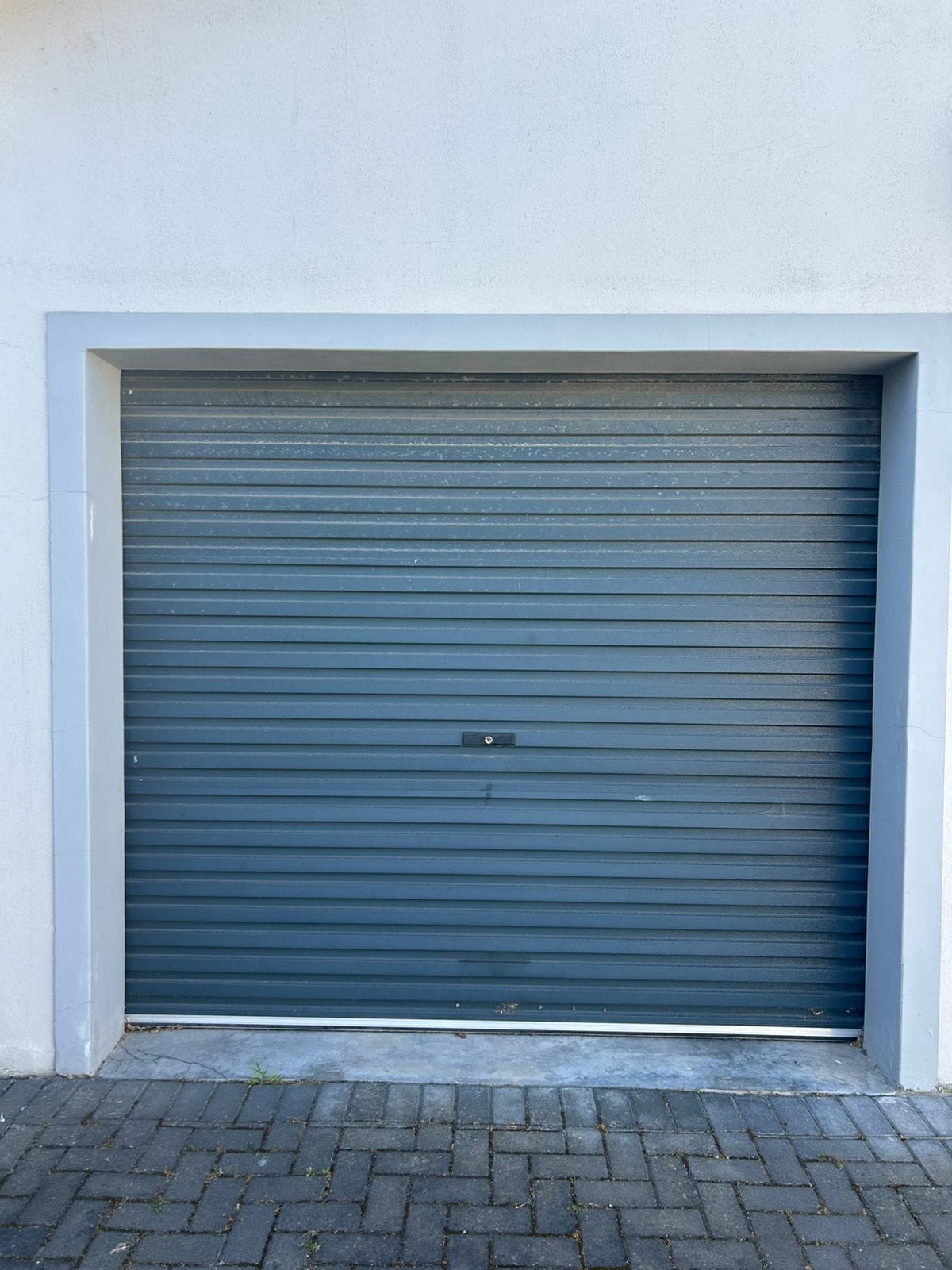 Blue-grey roller shutter door serviced in Cape Town