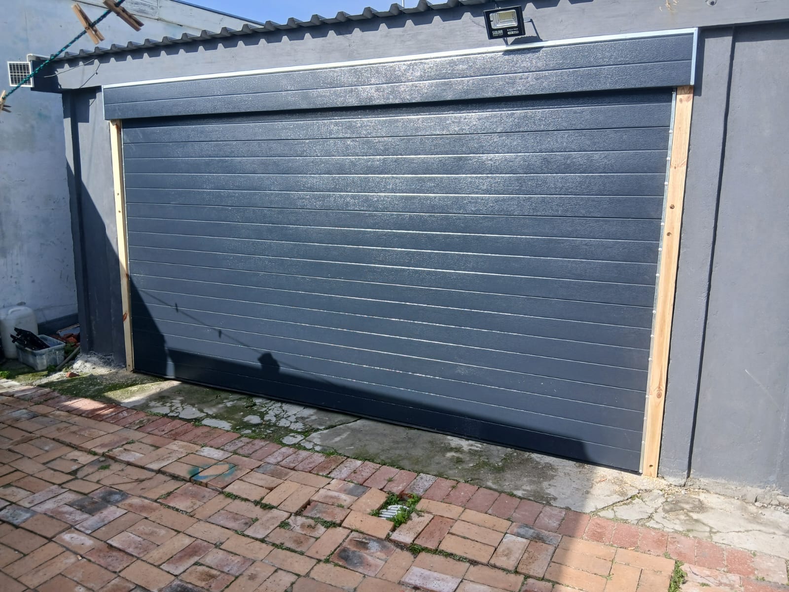 Charcoal garage door hung on a new timber frame