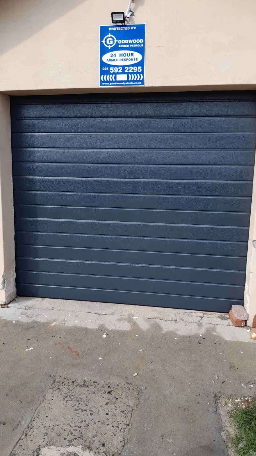 Charcoal garage door at a secured property