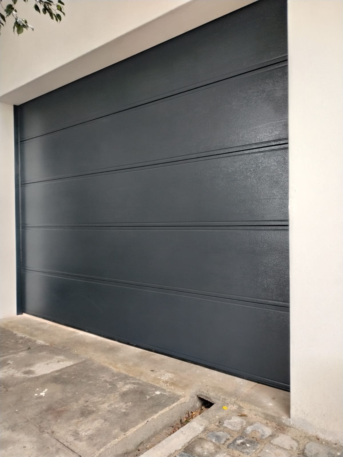 Wide-slat charcoal garage door close up