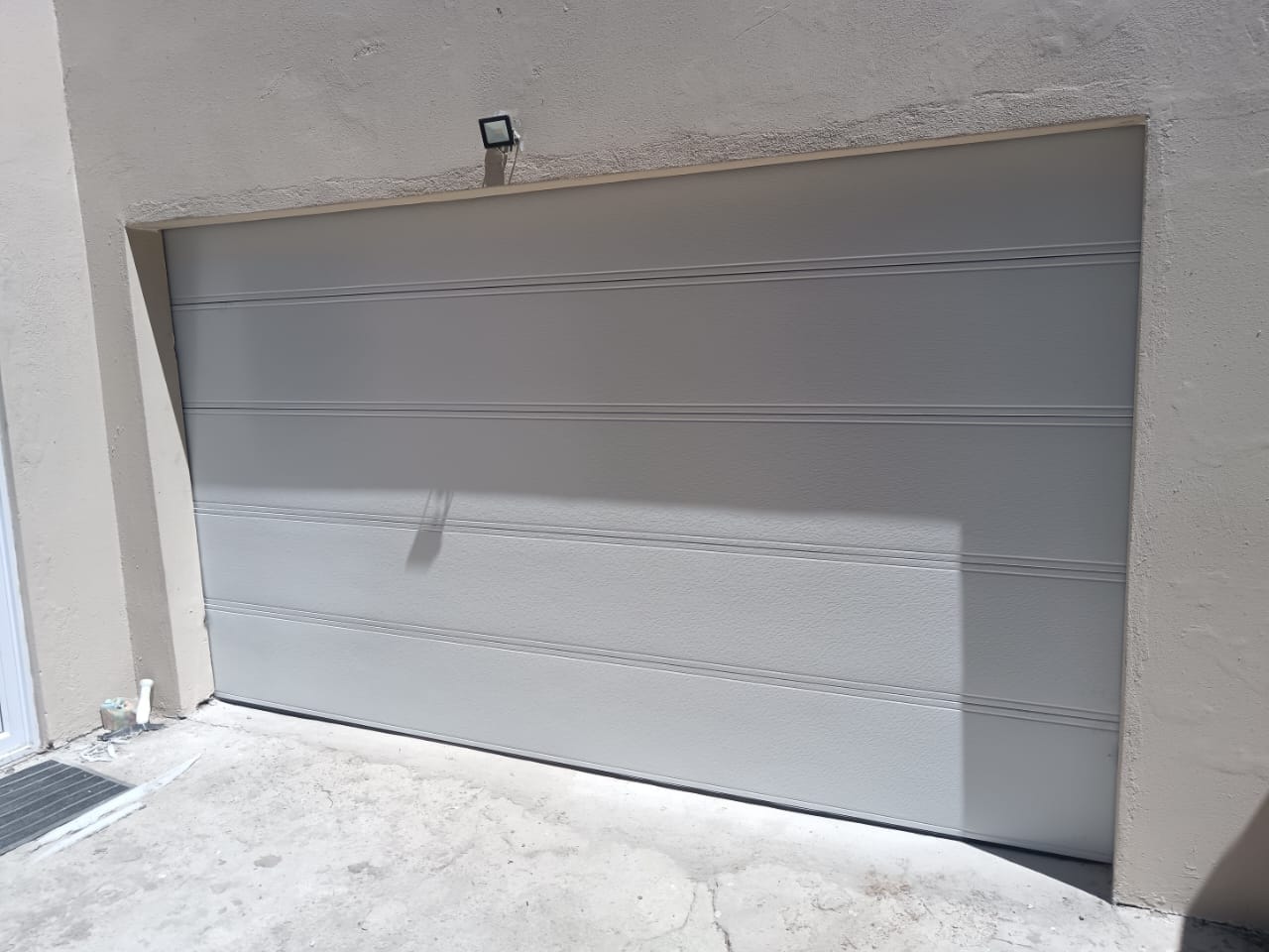 Light grey double garage door installed and finished