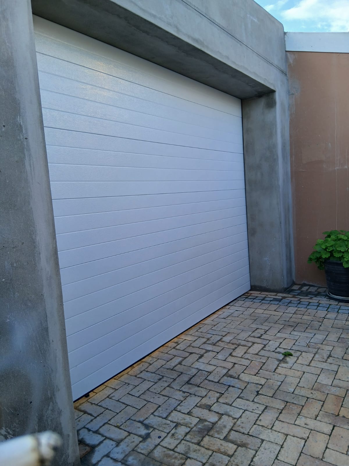 White sectional garage door in a concrete surround