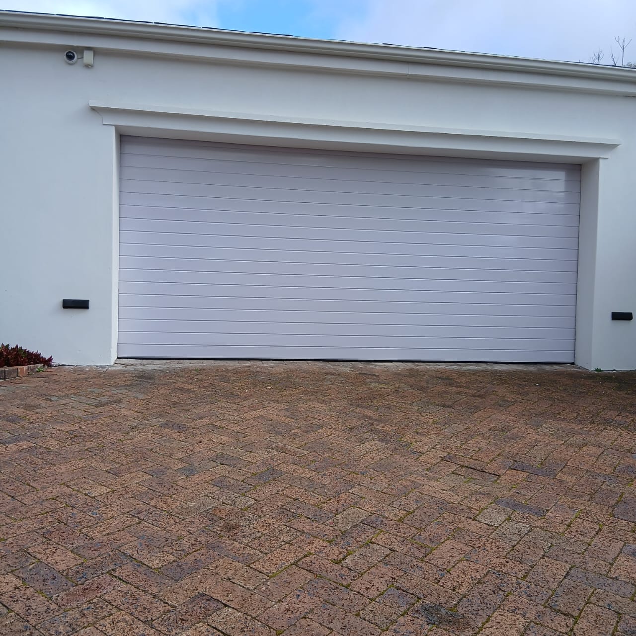 White sectional garage door fitted to a double garage in Cape Town