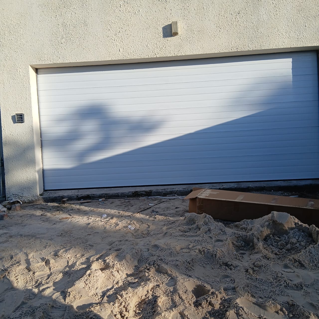 White sectional garage door on a new build